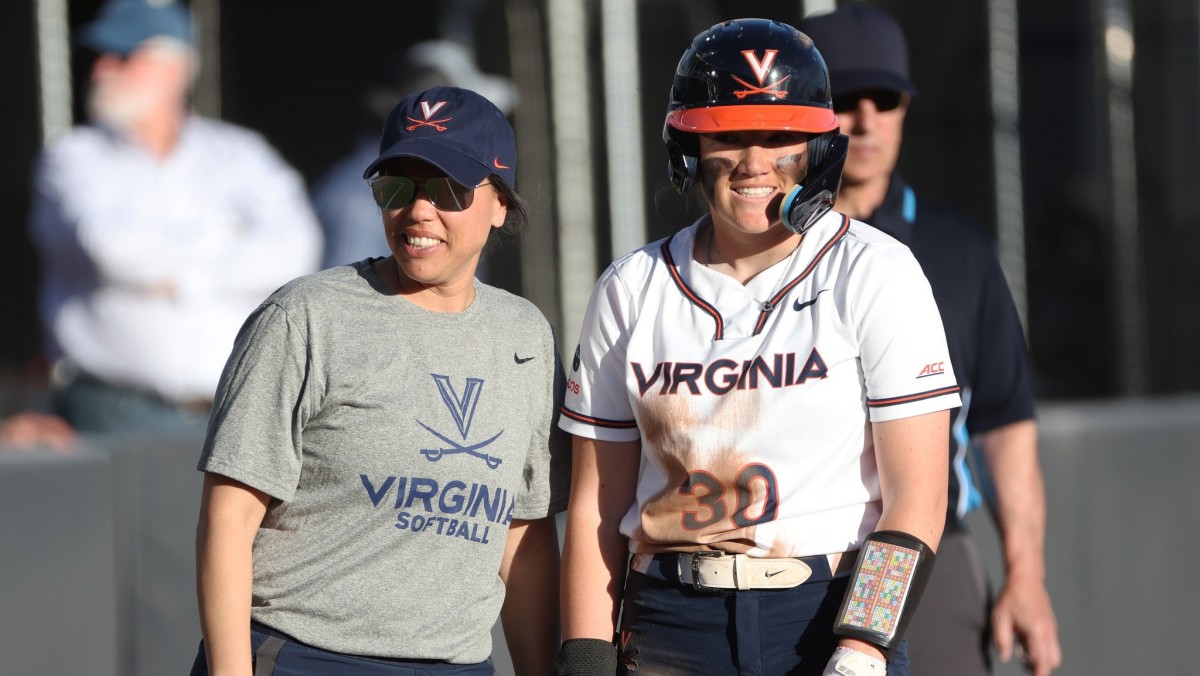 Joanna Hardin and Gabby Baylog talk on third base during the Virginia softball game against Longwood at Palmer Park.